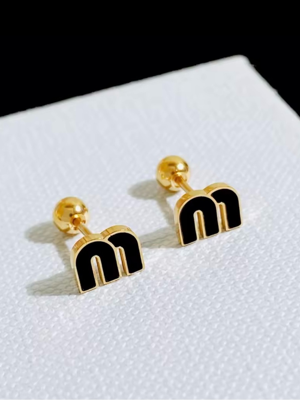 Gold-tone Black 'M' Stud Earrings